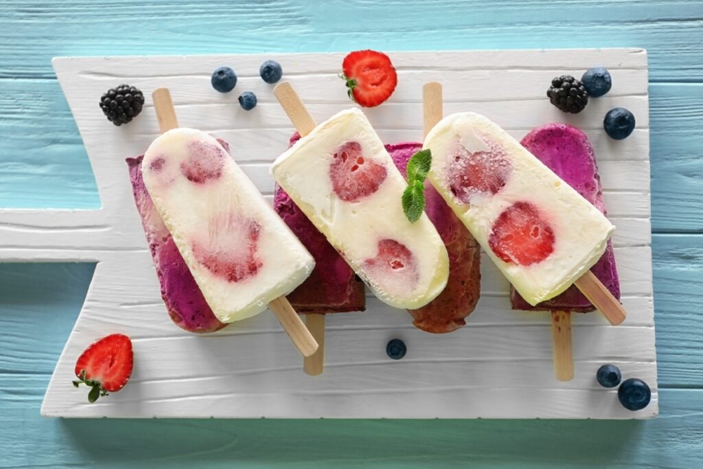 Home-made vanilla and strawberry popsicles