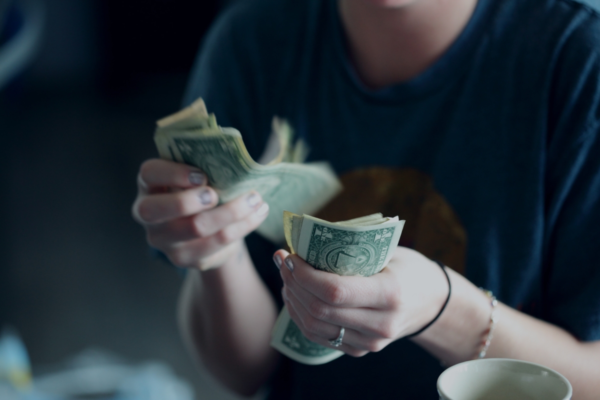 Woman Counting stack of money 