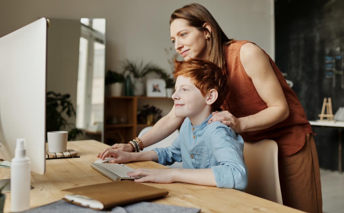 Mother helping son with school work on a  computer.