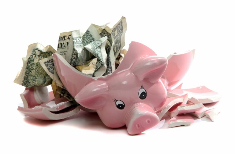 broken piggy bank showing money